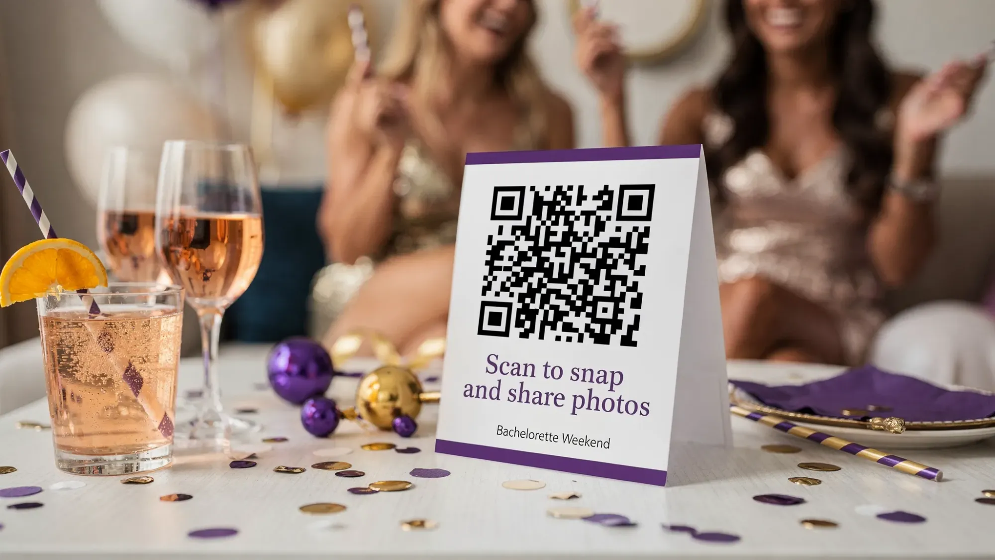 A bachelorette weekend table tent sign with a large QR code and simple copy that says “Scan to snap and share photos” placed next to drinks and party decorations, designed to be easy to notice in a lively indoor setting.