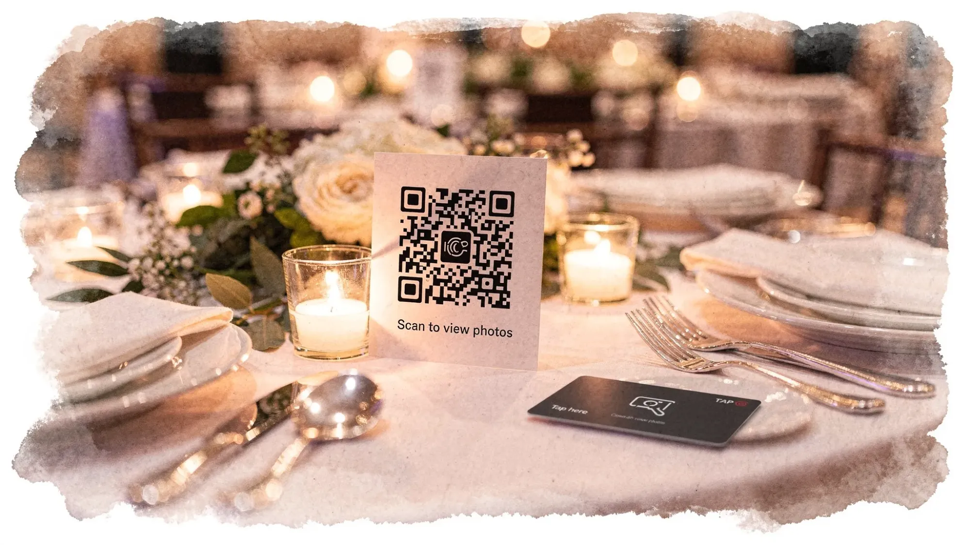 A wedding reception table scene with a small table tent displaying a QR code and a short instruction line, placed next to place settings and candles, with an NFC tap card nearby.